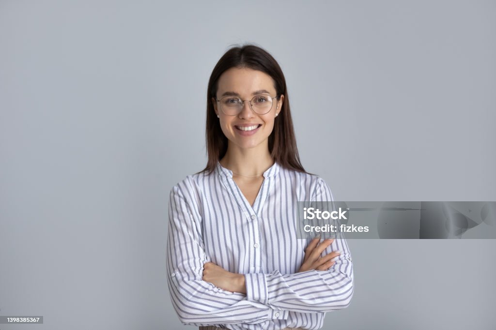 Placeholder image of woman in a dress shirt. She is smiling at the camera.